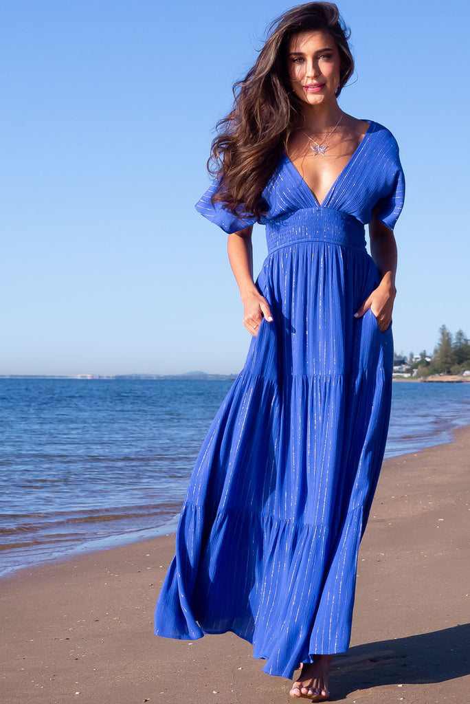 The striking Romance Aphrodite Blue Maxi Dress gives a subtle nod to glamorous past eras with its glittering pinstripe and elegant silhouette – perfect for dinner dates and evening events. Whether you're on the beachfront or rooftop, this dress is sure to impress. 100% crinkle viscose.