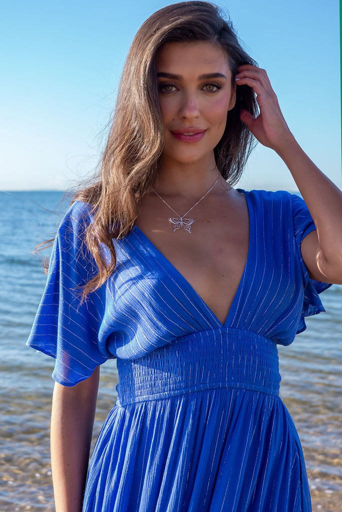 The striking Romance Aphrodite Blue Maxi Dress gives a subtle nod to glamorous past eras with its glittering pinstripe and elegant silhouette – perfect for dinner dates and evening events. Whether you're on the beachfront or rooftop, this dress is sure to impress. 100% crinkle viscose.