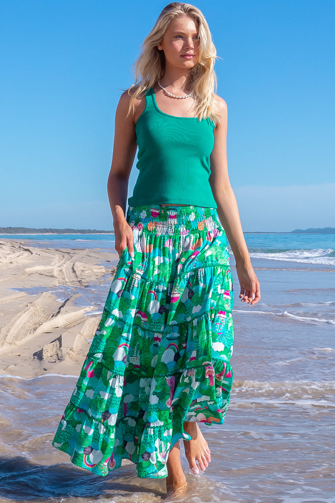 The Rozita Faraway Green Tiered Maxi Skirt is a gorgeous green based maxi skirt with an abstract tree print. The maxi skirt features side pockets, tiering, green ric-rac on each tier and an elasticated waistband. Made from 100% cotton.