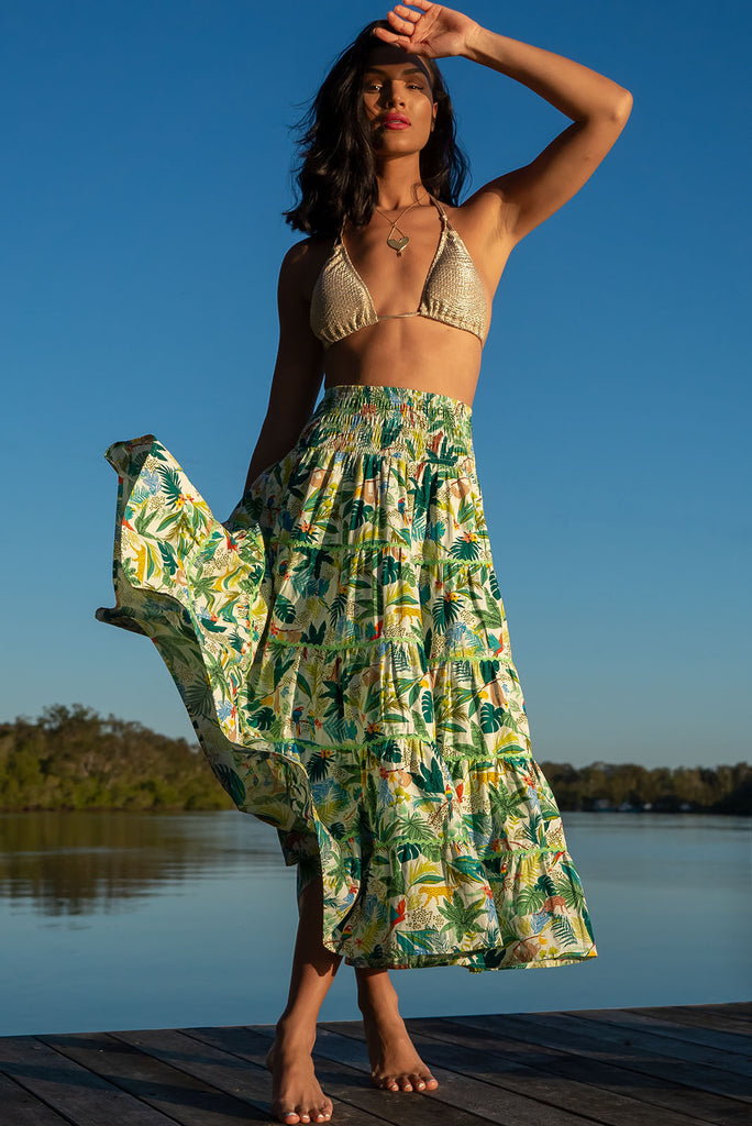 For a luxe look you're sure to adore we recommend the Rozita Green Jungle Tiered Maxi Skirt. The luscious green, leafy print featuring exotic animals will have you daydreaming of a warm tropical holiday. Cotton, Lightweight, shirred waistband, slip-on style, pockets, ric rac feature.