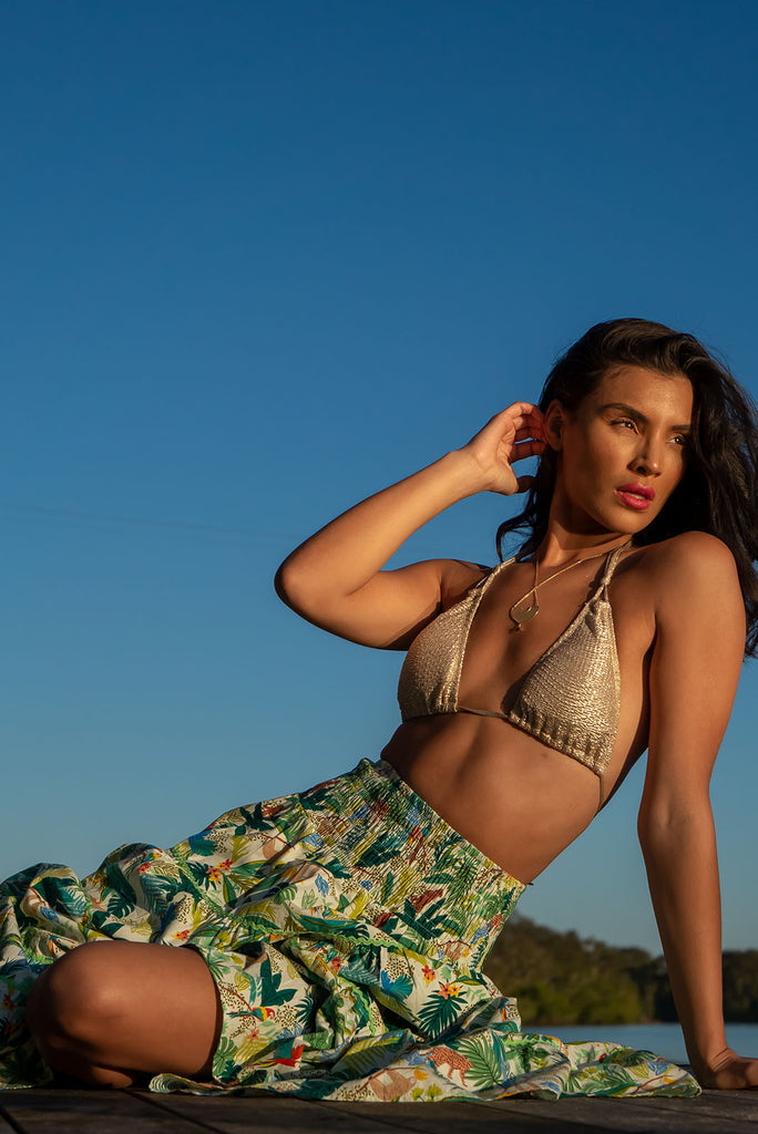 For a luxe look you're sure to adore we recommend the Rozita Green Jungle Tiered Maxi Skirt. The luscious green, leafy print featuring exotic animals will have you daydreaming of a warm tropical holiday. Cotton, Lightweight, shirred waistband, slip-on style, pockets, ric rac feature.
