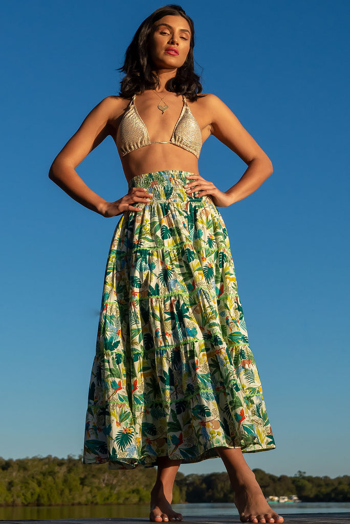 For a luxe look you're sure to adore we recommend the Rozita Green Jungle Tiered Maxi Skirt. The luscious green, leafy print featuring exotic animals will have you daydreaming of a warm tropical holiday. Cotton, Lightweight, shirred waistband, slip-on style, pockets, ric rac feature.