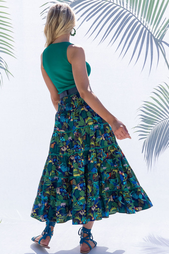 The Rozita Night Jungle Tiered Maxi Skirt is an inky navy based skirt with a colourful jungle print. The maxi skirt features side pockets, ric-rac, tiering and an elasticated waistband, and is made from 100% cotton.