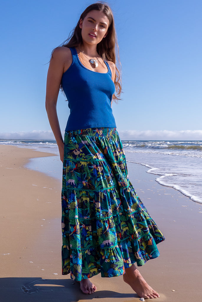 The Rozita Night Jungle Tiered Maxi Skirt is an inky navy based skirt with a colourful jungle print. The maxi skirt features side pockets, ric-rac, tiering and an elasticated waistband, and is made from 100% cotton.