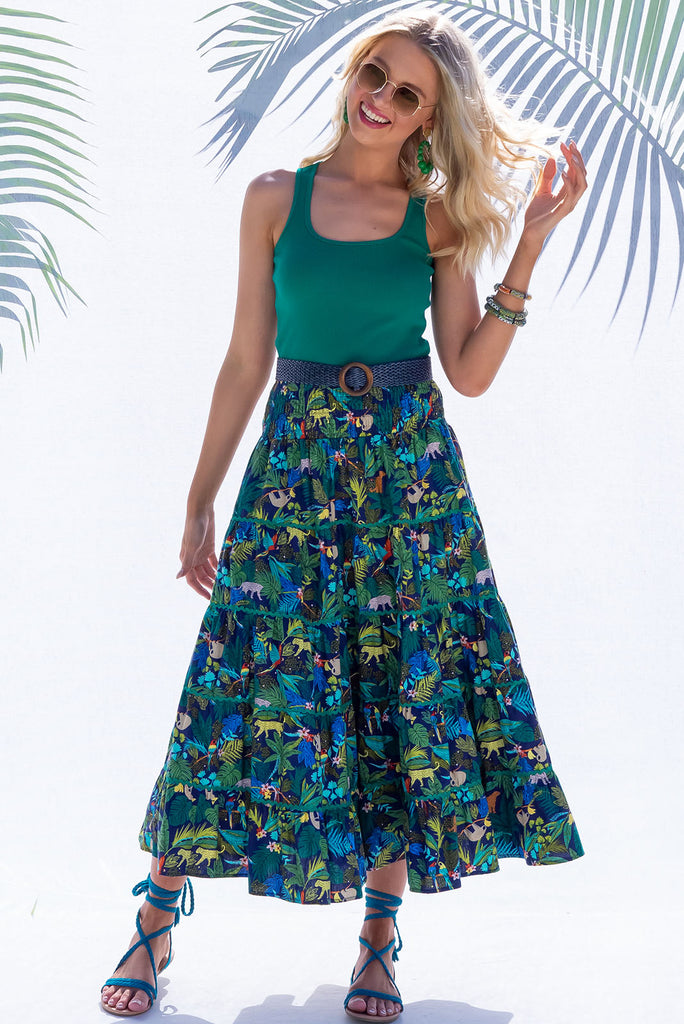 The Rozita Night Jungle Tiered Maxi Skirt is an inky navy based skirt with a colourful jungle print. The maxi skirt features side pockets, ric-rac, tiering and an elasticated waistband, and is made from 100% cotton.