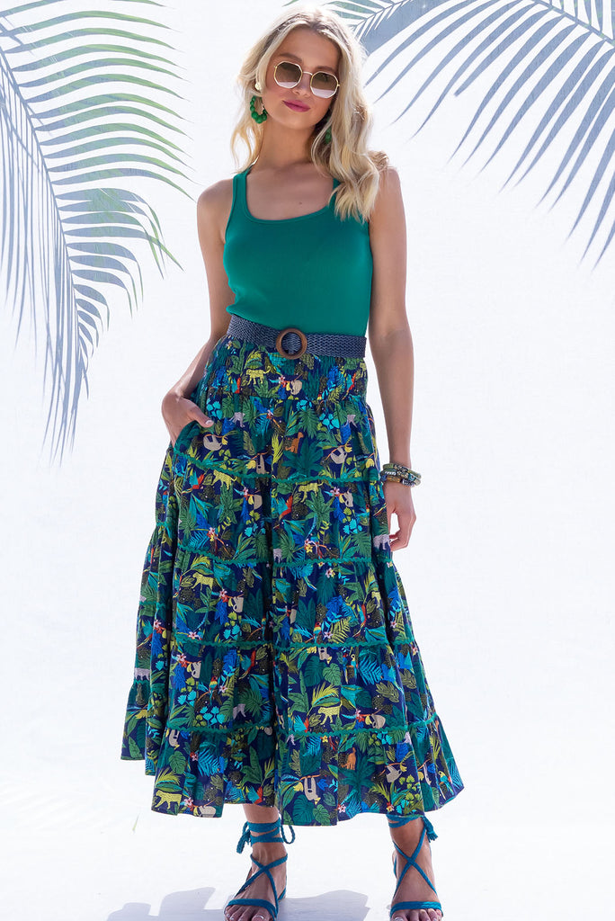 The Rozita Night Jungle Tiered Maxi Skirt is an inky navy based skirt with a colourful jungle print. The maxi skirt features side pockets, ric-rac, tiering and an elasticated waistband, and is made from 100% cotton.