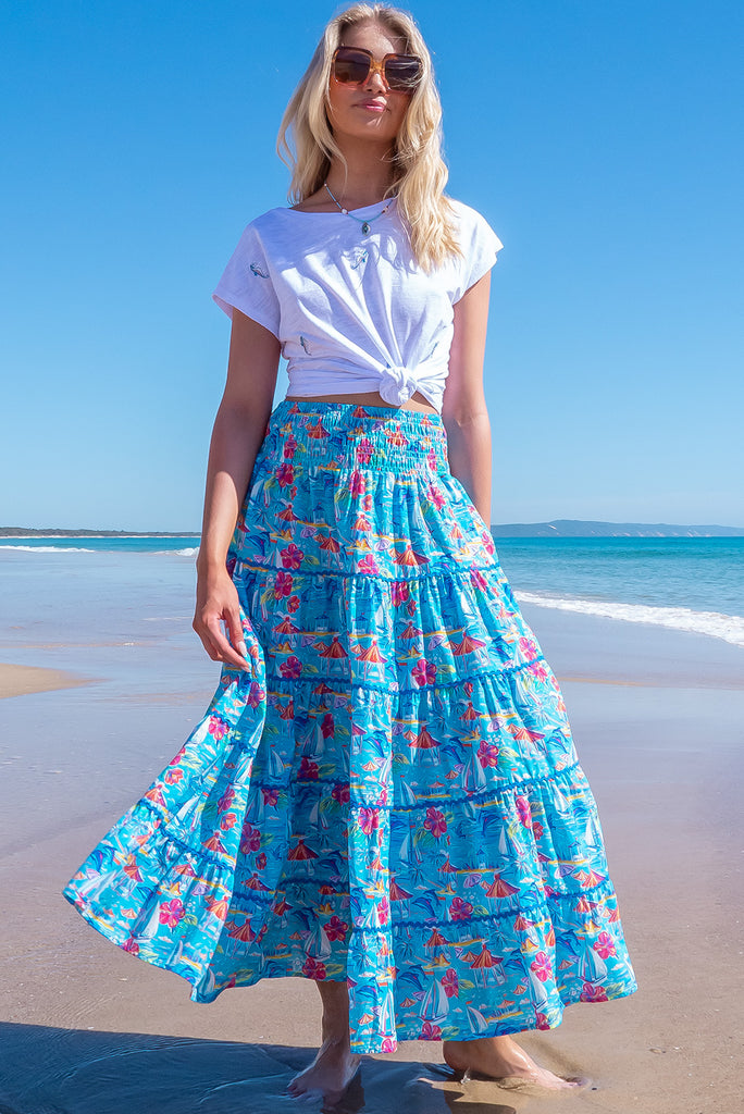 The Rozita Paradise Tiered Maxi Skirt is a gorgeous sky blue maxi skirt with a tropical floral and sailboat print all over. The maxi skirt features side pockets, tiering, blue ric-rac on each tier and an elasticated waistband. Made from 100% cotton.