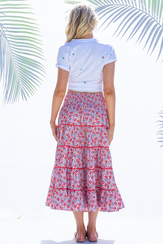 Swirl softly into the new season wearing the lovely Rozita Pink Tiered Maxi Skirt. Airy and sweet, this gorgeous separate will see you through spring and summer in effortless style and complete comfort. Cotton, shirred waistband, pockets, pink floral print and red ric-rac feature.