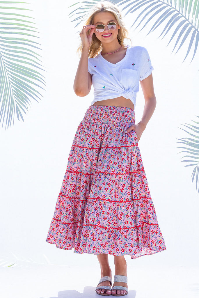 Swirl softly into the new season wearing the lovely Rozita Pink Tiered Maxi Skirt. Airy and sweet, this gorgeous separate will see you through spring and summer in effortless style and complete comfort. Cotton, shirred waistband, pockets, pink floral print and red ric-rac feature.