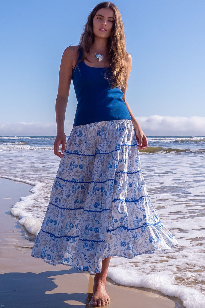She sell sea shells in the Rozita Seashells Tiered Maxi Skirt! Live out all of your magical mermaid dreams in this luxe, holiday-ready seperate. 100% cotton, Lightweight, shirred waistband, slip-on style, Tiered for fullness, pockets.,White base with sea shell outline, ric rac feature.