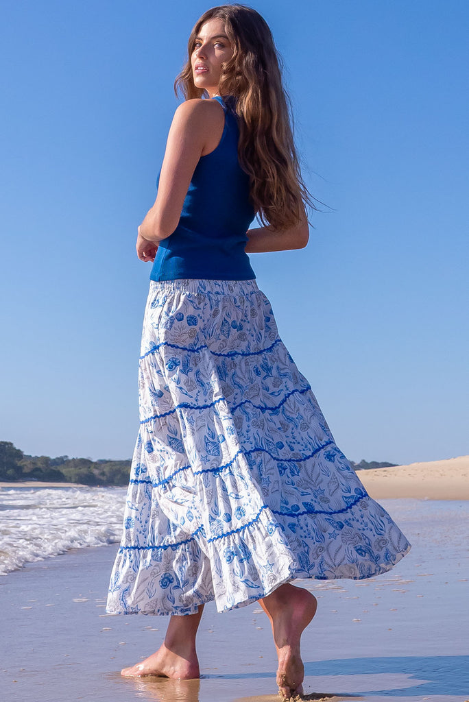 She sell sea shells in the Rozita Seashells Tiered Maxi Skirt! Live out all of your magical mermaid dreams in this luxe, holiday-ready seperate. 100% cotton, Lightweight, shirred waistband, slip-on style, Tiered for fullness, pockets.,White base with sea shell outline, ric rac feature.