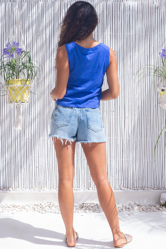 The Tali Sapphire Blue Tank Top is a classic tank top featuring sleeveless, slim fit over the bust, relaxed over the waist & hips and 55% cotton, 45% polyester in dark bright blue colour.