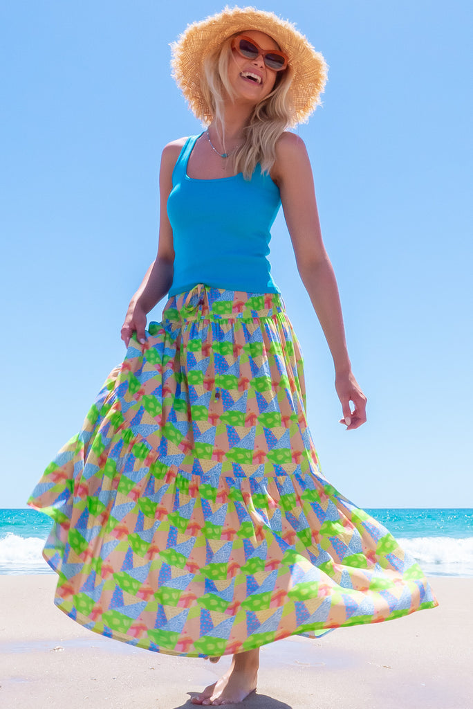 The Valencia Limes Leaves Maxi Skirt features an elasticated waistband with drawstring, a double tiered skirt and side pockets. The Lime Leaves print is a green, blue and orange patchwork print. Made from woven 100% rayon.