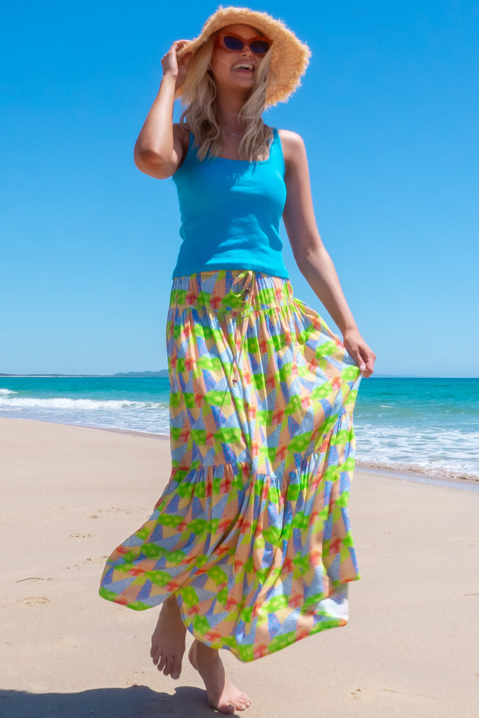 The Valencia Limes Leaves Maxi Skirt features an elasticated waistband with drawstring, a double tiered skirt and side pockets. The Lime Leaves print is a green, blue and orange patchwork print. Made from woven 100% rayon.