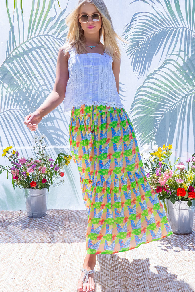 The Valencia Limes Leaves Maxi Skirt features an elasticated waistband with drawstring, a double tiered skirt and side pockets. The Lime Leaves print is a green, blue and orange patchwork print. Made from woven 100% rayon.