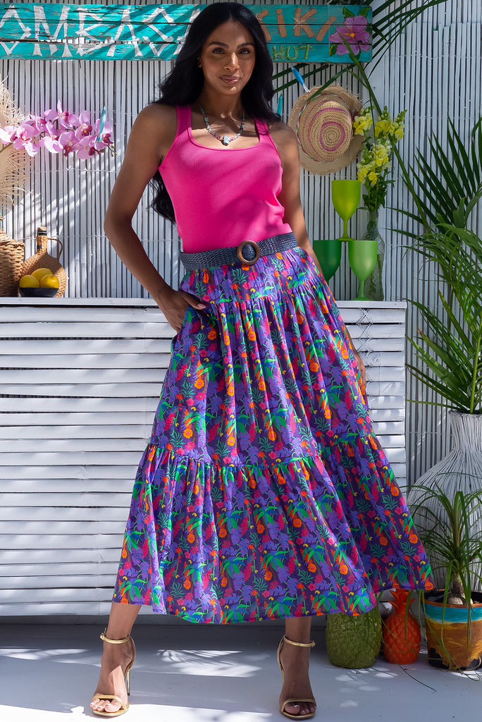 The Valencia Tropical Chaos Maxi Skirt is a vibrant purple based skirt with a bright multicoloured tropical print, exclusive to Mombasa Rose Boutique. The maxi skirt features and elasticated waistband, drawstring waist and side pockets. Made from a cotton/rayon blend.