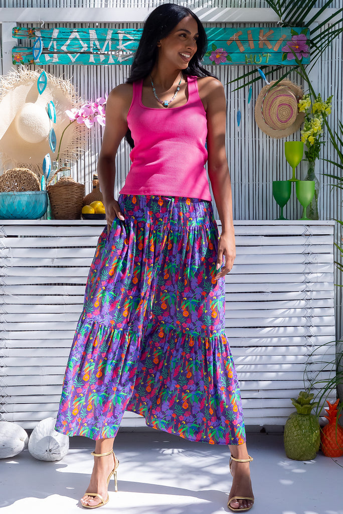 The Valencia Tropical Chaos Maxi Skirt is a vibrant purple based skirt with a bright multicoloured tropical print, exclusive to Mombasa Rose Boutique. The maxi skirt features and elasticated waistband, drawstring waist and side pockets. Made from a cotton/rayon blend.