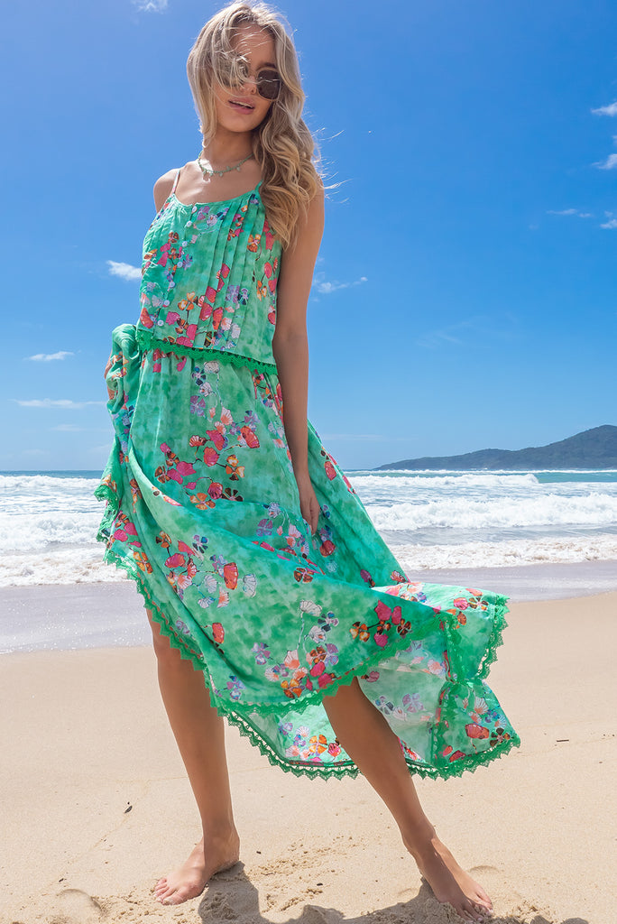 The Valentine Glass Green Cami Top is gorgeous cami top with a green wash effect base and a botanical print. The top features a button front, pintuck features on hem, adjustable thin straps, lace detail on hem and a soft cut. Made from a woven cotton/rayon blend.