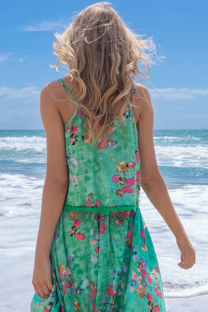 The Valentine Glass Green Cami Top is gorgeous cami top with a green wash effect base and a botanical print. The top features a button front, pintuck features on hem, adjustable thin straps, lace detail on hem and a soft cut. Made from a woven cotton/rayon blend.