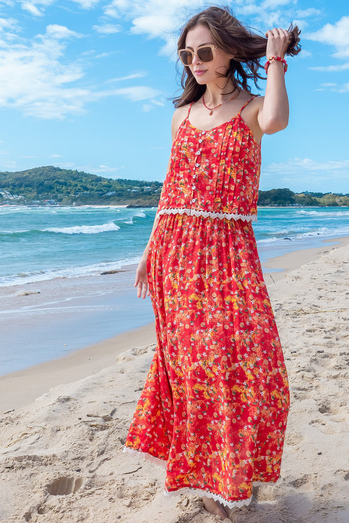 The Valentine Summer Sun Half Circle Maxi Skirt is a gorgeous maxi skirt with a red wash effect base and a fruit vine print. The skirt features and elasticated waistband, side pockets, half circle cut, lace detail on hem and is a slip on design. Made from a woven cotton/rayon blend.