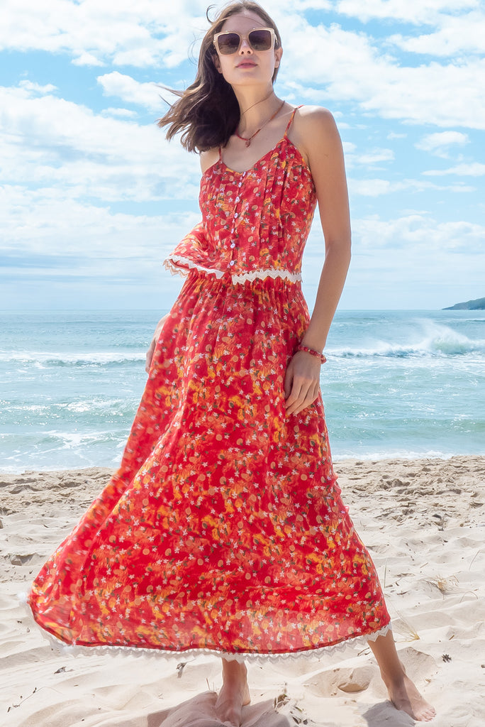 The Valentine Summer Sun Half Circle Maxi Skirt is a gorgeous maxi skirt with a red wash effect base and a fruit vine print. The skirt features and elasticated waistband, side pockets, half circle cut, lace detail on hem and is a slip on design. Made from a woven cotton/rayon blend.