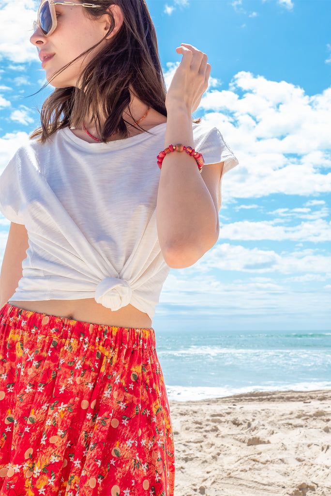 The Valentine Summer Sun Half Circle Maxi Skirt is a gorgeous maxi skirt with a red wash effect base and a fruit vine print. The skirt features and elasticated waistband, side pockets, half circle cut, lace detail on hem and is a slip on design. Made from a woven cotton/rayon blend.