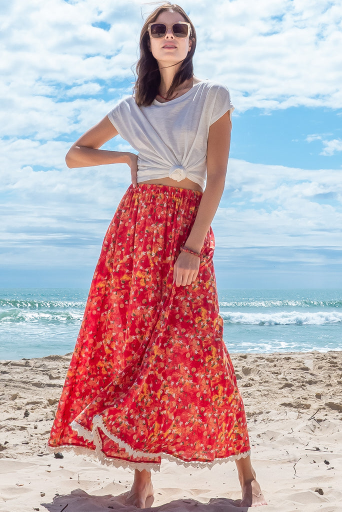 The Valentine Summer Sun Half Circle Maxi Skirt is a gorgeous maxi skirt with a red wash effect base and a fruit vine print. The skirt features and elasticated waistband, side pockets, half circle cut, lace detail on hem and is a slip on design. Made from a woven cotton/rayon blend.