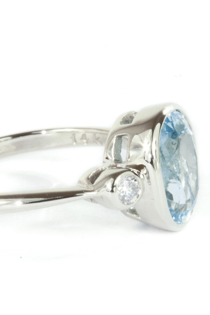 A signature designer piece. This classically styled ring holds a magnificent 10x8mm 2ct+ completely natural and unheated Mozambique Aquamarine with a sparkling 0.03ct F-G VS diamond on either side.