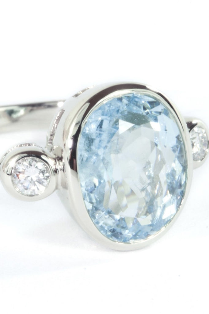 A signature designer piece. This classically styled ring holds a magnificent 10x8mm 2ct+ completely natural and unheated Mozambique Aquamarine with a sparkling 0.03ct F-G VS diamond on either side.