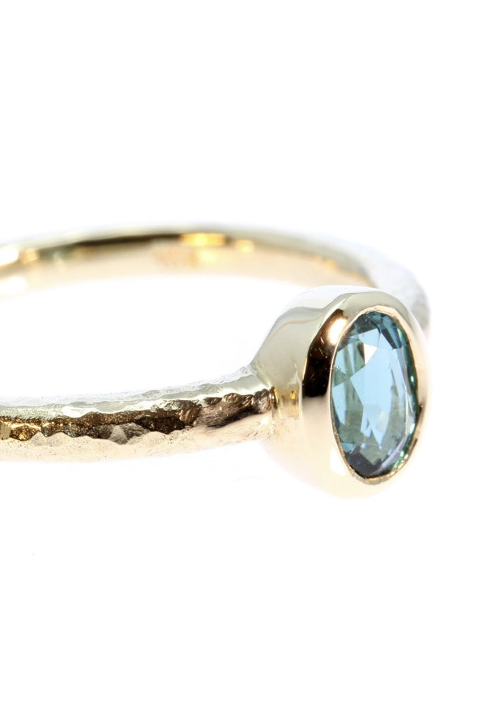 The hammered band on this ring has a slightly textured finish, giving it a hand made feel, complementing the beautiful 6x4mm natural blue tourmaline gemstone set into the ring.