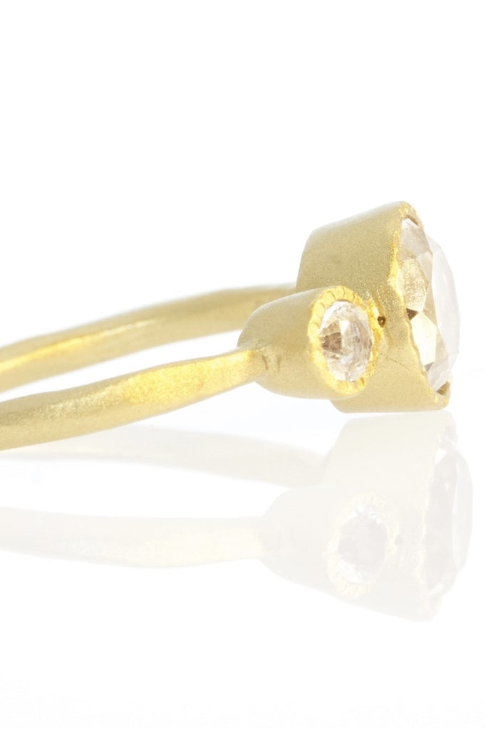 A very stunning ring, set with three clear sparkling faceted white topaz gemstones. The band is gold vermeil and is adjustable so it can be made a little bigger or smaller 