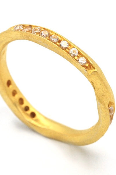 A very unusual and interesting ring, the band has a carved in chanel design which is set with twelve bright sparkling white topaz.